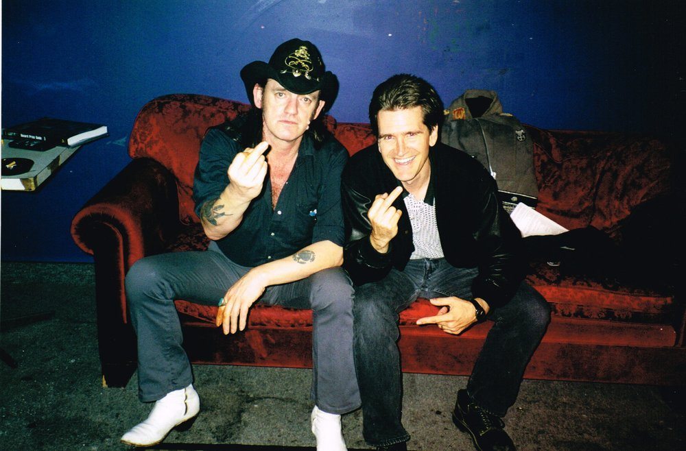 Martin Popoff (right) and Lemmy giving the middle-finger salute.